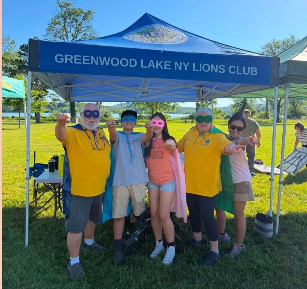 Group in superhero masks and capes at the Greenwood Lake tent